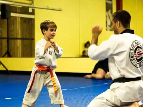 a person and a boy in karate uniforms