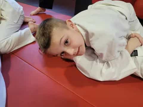 a boy lying on a red surface