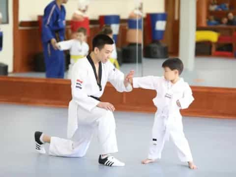 a couple of boys in karate uniforms