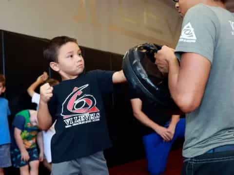 a person and a boy holding a helmet