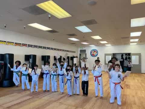 a group of children in karate uniforms