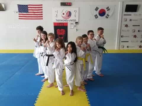 a group of children in karate uniforms