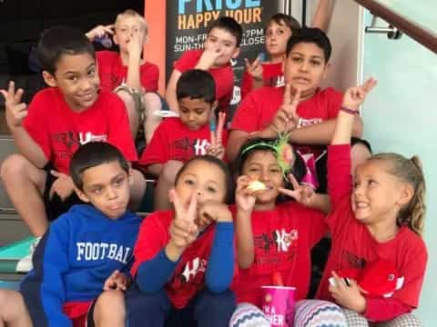 a group of children in red shirts