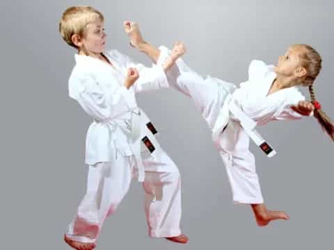 a few children in karate uniforms
