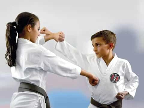 a woman and a man in karate uniforms