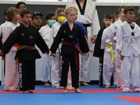 a group of children in karate uniforms