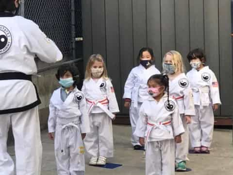 a group of people wearing white masks