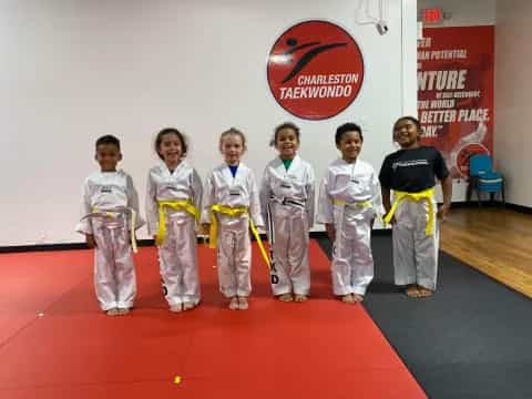 a group of kids in karate uniforms