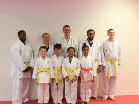 a group of people in white karate uniforms