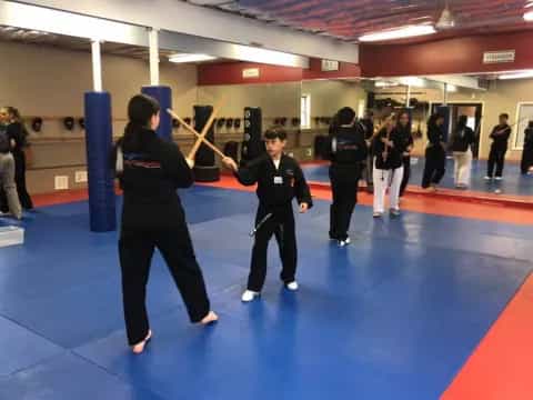 a couple of people in a karate class