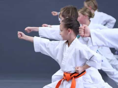 a group of people in karate uniforms