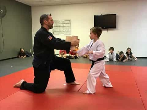 a man and a boy practicing martial arts