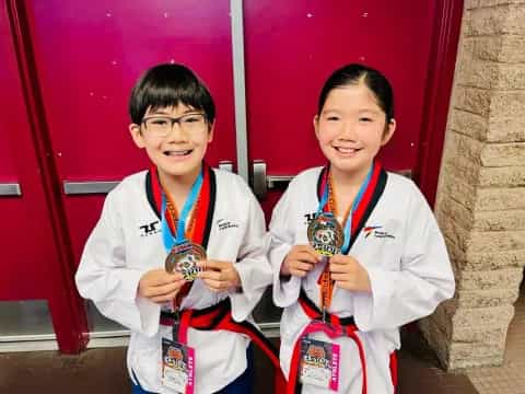 a couple of boys wearing medals