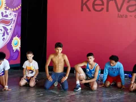 a group of boys sitting on the floor