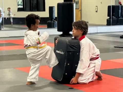 a couple of kids in karate uniforms