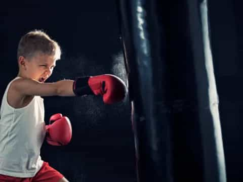 a boy wearing boxing gloves