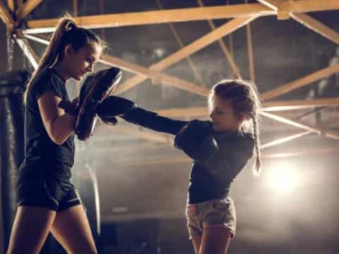 a couple of girls playing with a toy gun