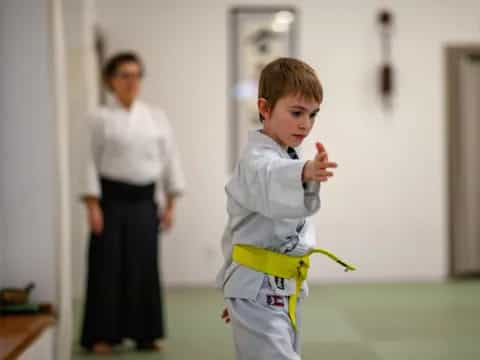 a boy in a karate uniform