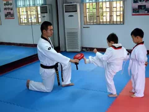 a group of kids in karate uniforms