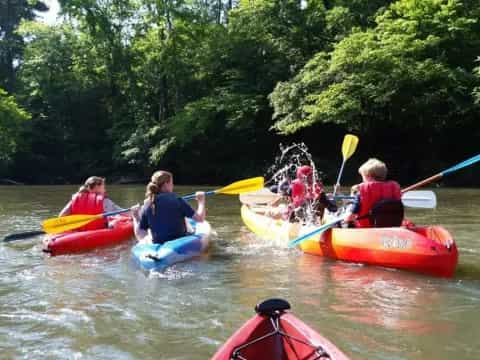 a group of people in kayaks on a river