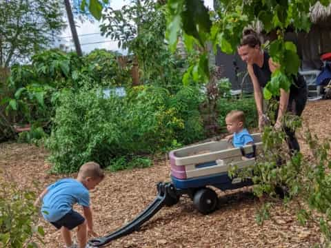 a man and two children in a garden