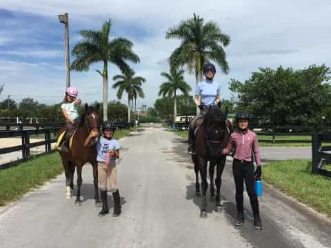 a group of people walking horses