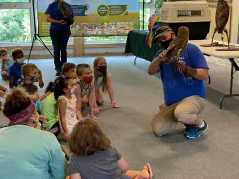 a person playing a saxophone in front of a group of children