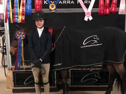 a person standing next to a horse