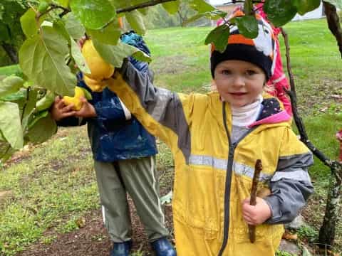 a boy and a girl holding fruits