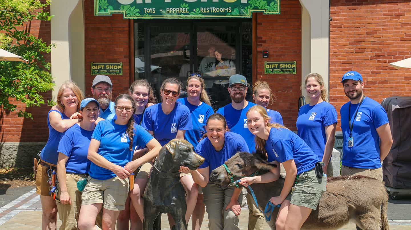 a group of people posing for a photo with a dog