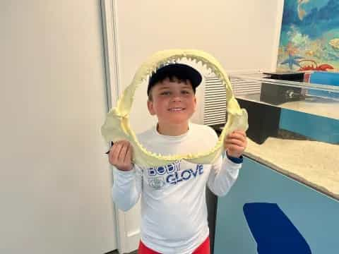 a boy holding a banana