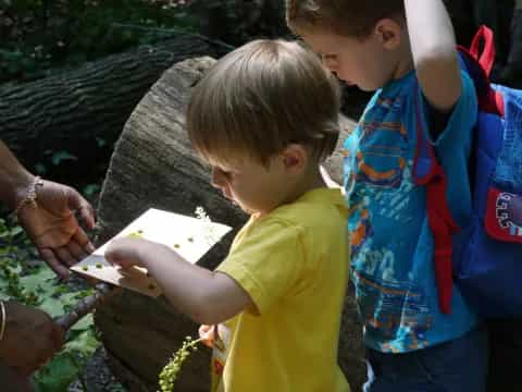 a person and a child looking at a piece of paper