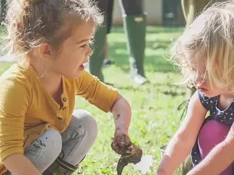 a group of children sitting on the grass