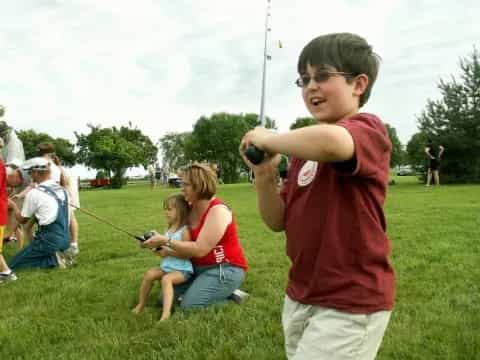 a boy holding a fishing pole
