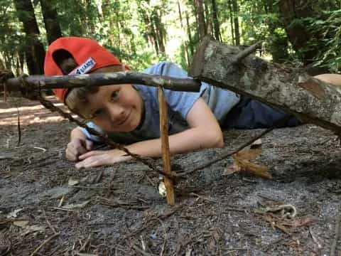 a boy lying on a log