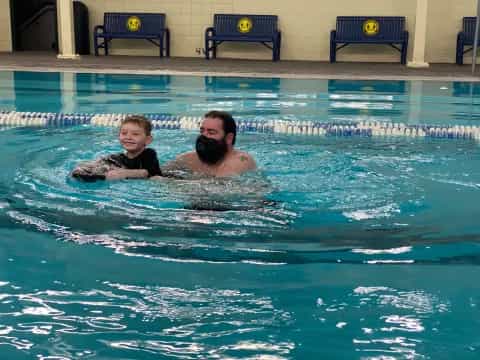 a person and a child in a pool