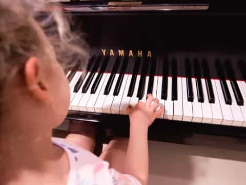a girl playing a piano