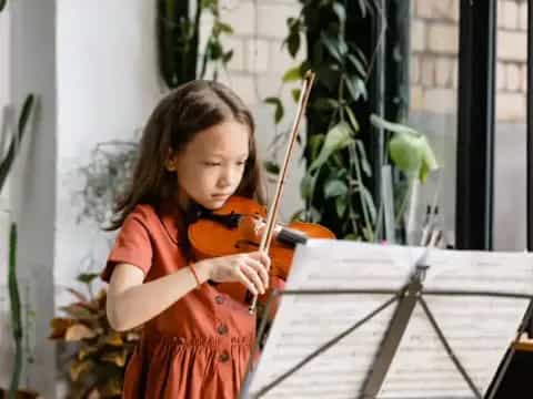 a girl playing a violin