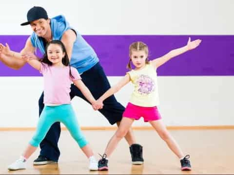 a person and two girls dancing