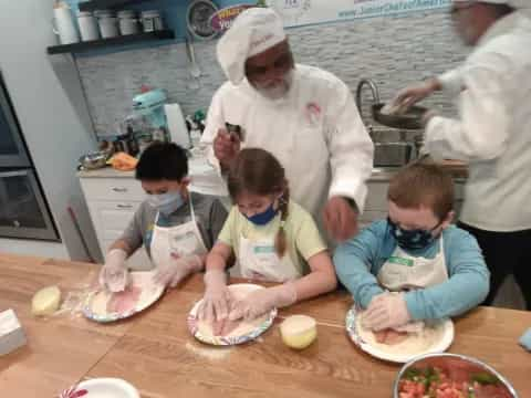 a group of kids making food