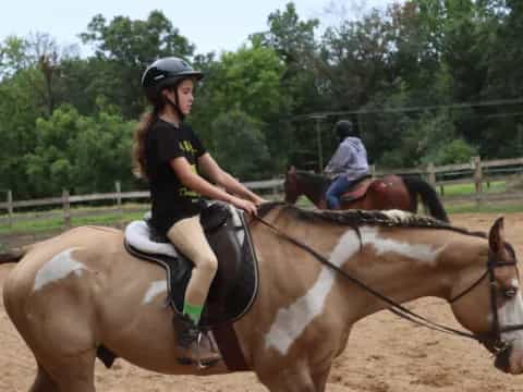 a couple of people riding horses