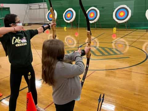 a couple of people shooting bows