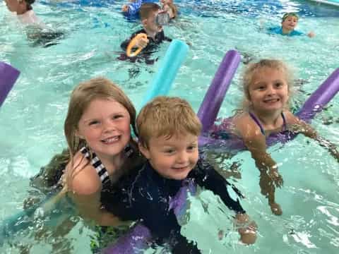 a group of children in a pool