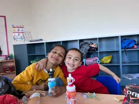 two boys sitting at a table