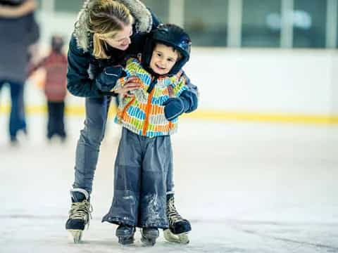 a person and a child ice skating