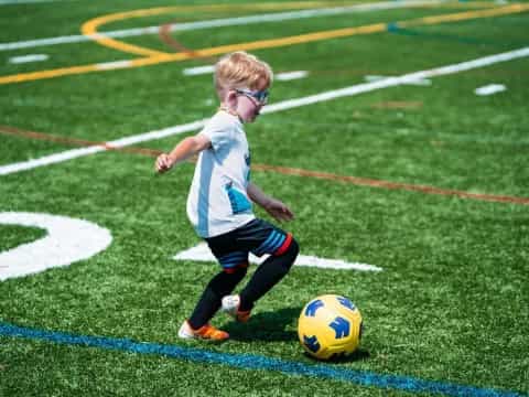 a young boy playing football