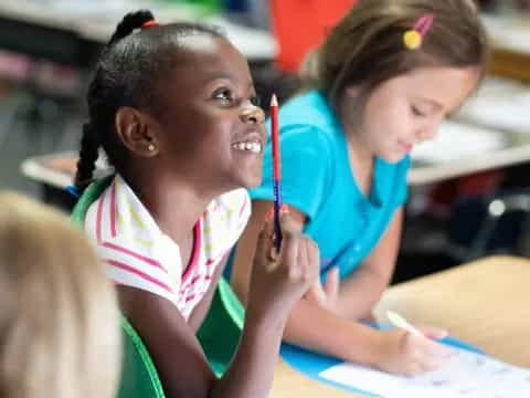 a few young girls in a classroom