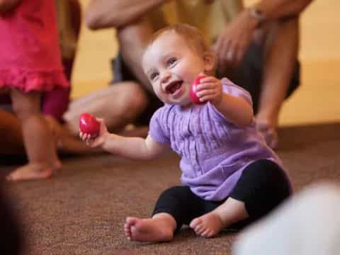 a baby holding a toy
