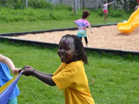 a girl holding a toy