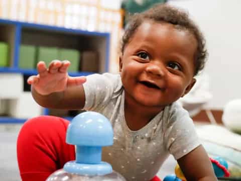 a baby sitting on a toy